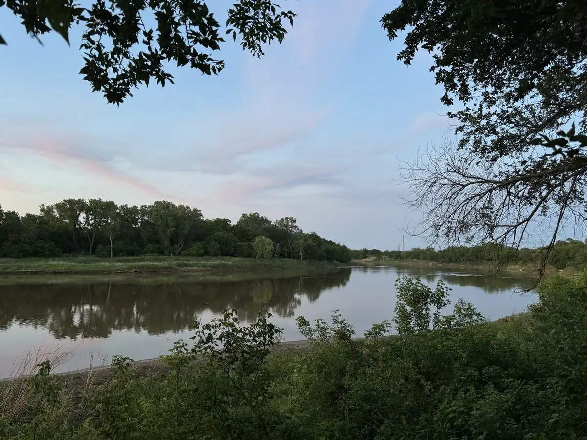 The Salt Fork River at dusk, framed by trees