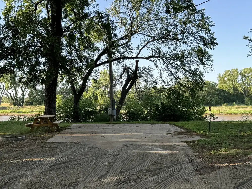 Shaded RV site with picnic table in summer